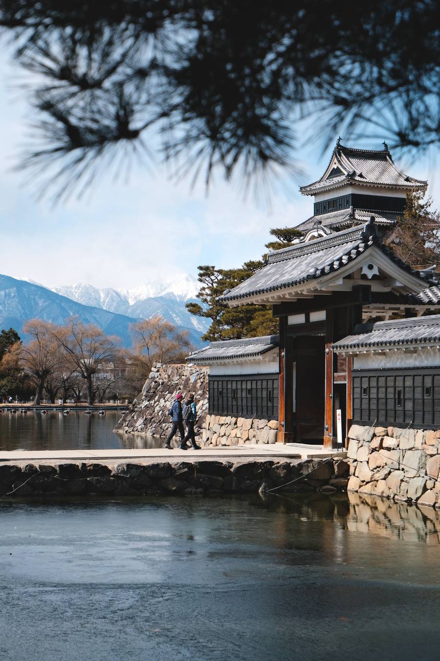 Matsumoto Castle's gate with the snow-capped Japan Alps in the background
